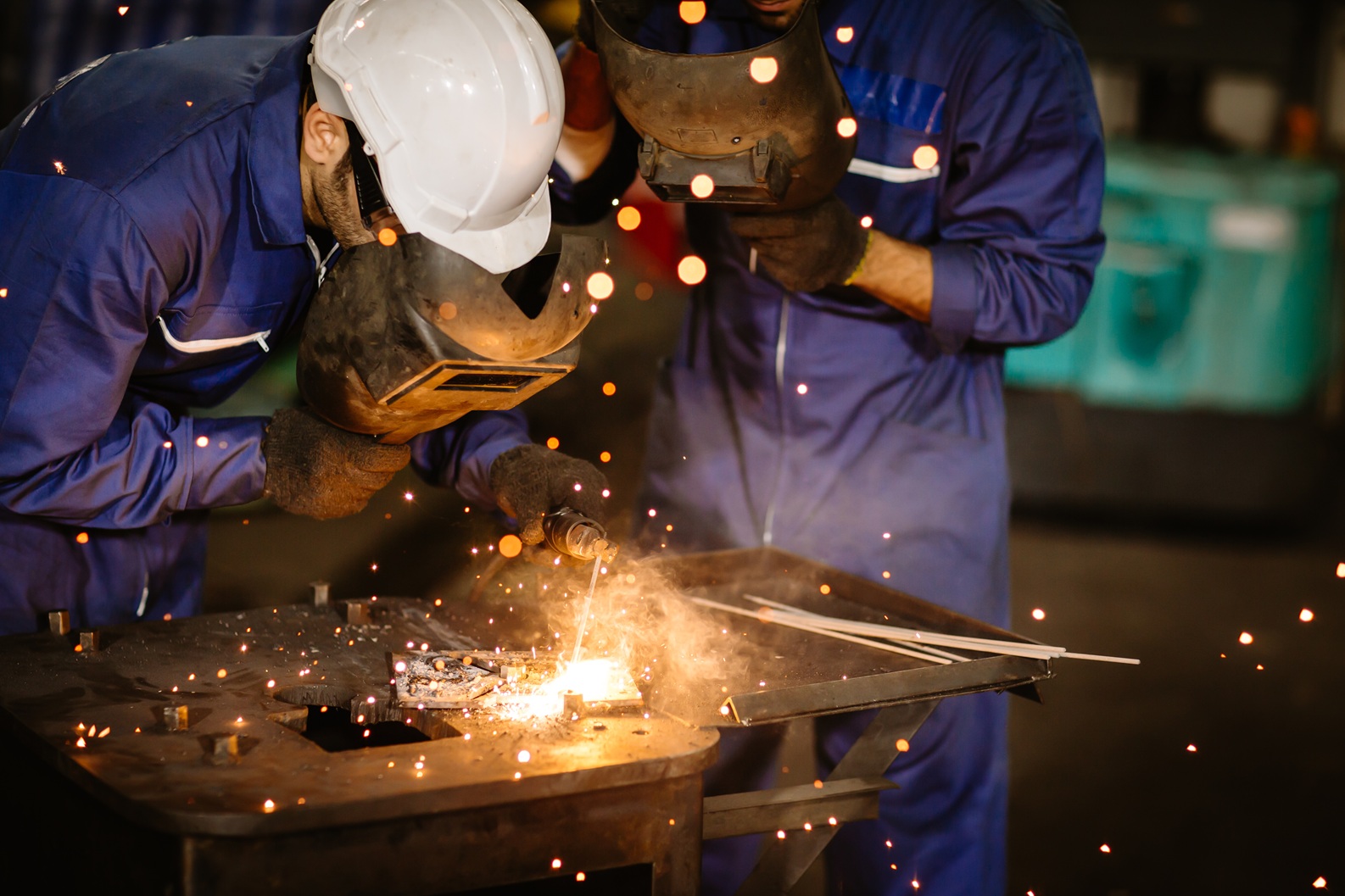 industry worker tig welding steel with safety mask for protect eyesight in metal factory. kaufmann